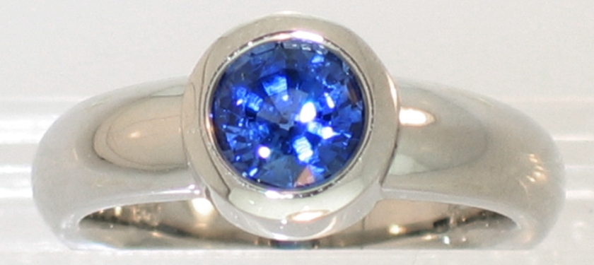 14 Karat White Gold Solitaire with round Blue Sapphire in heavy bezel Setting